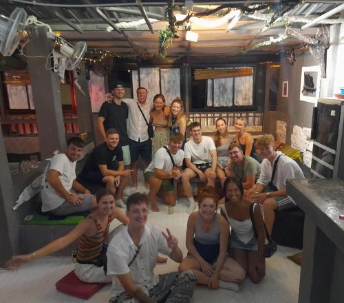 a group of people posing for a picture in a room at Dormsin Social in Phi Phi Don