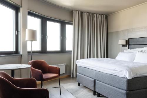 スタヴァンゲルにあるクラリオン ホテル スタヴァンゲルのベッド、テーブル、椅子が備わるホテルルームです。