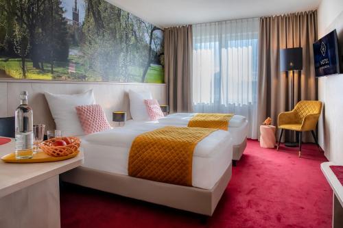 a hotel room with a large bed and a table at Hotel Restaurant Elbebrücke in Oranienbaum-Wörlitz