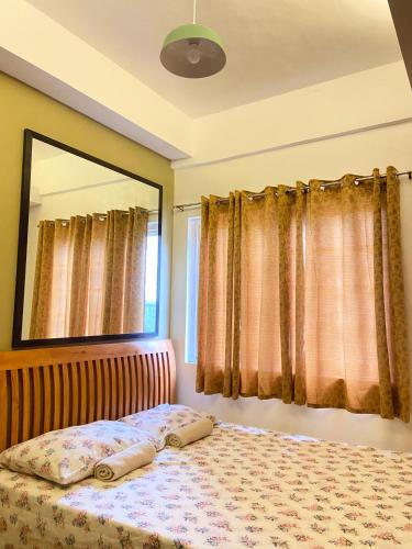 a bedroom with a bed and a large mirror at A nature’s den in Tagaytay in Tagaytay