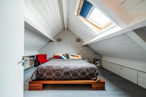 a bedroom with a bed in a attic at Welcome Gigi's Room 1 in Châteaubourg