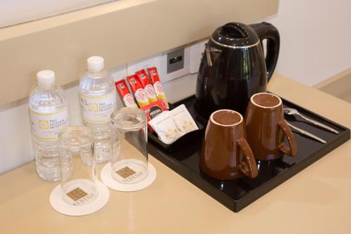 a counter top with two bottles of water and glasses at Serene Villa 38 in Kandy
