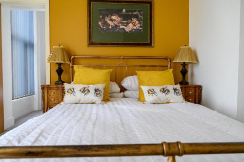 a bedroom with a large bed with yellow walls at The Sandbeck, Glaisdale in Whitby