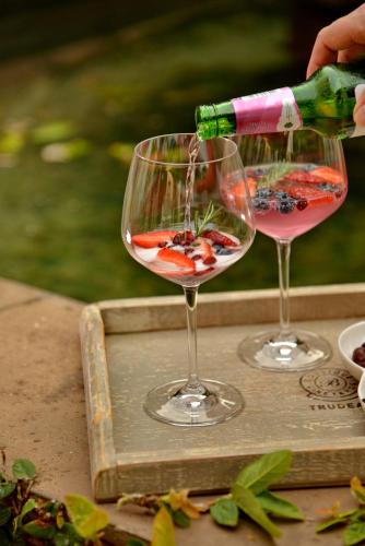 a person is pouring wine into two wine glasses at The Vineyard on Ballito in Ballito