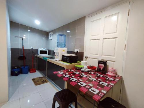 a kitchen with a counter with a table in it at TREX_Batu Pahat Homestay in Batu Pahat