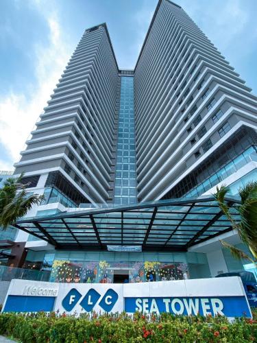 two tall buildings with a sign in front of it at FLC Sea Tower Quy Nhon SeaView Condotel in Quy Nhon