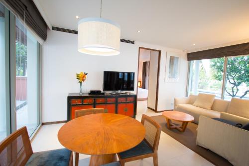 a living room with a table and a couch at Villa Nilaya - Beachfront Villa - Hua Hin in Ban Bo Fai