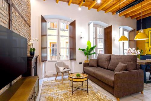 a living room with a couch and a table at Genteel Home Catedral Granada in Granada