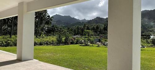 a view of a yard with a field of green grass at Temata Estate Rarotonga in Rarotonga