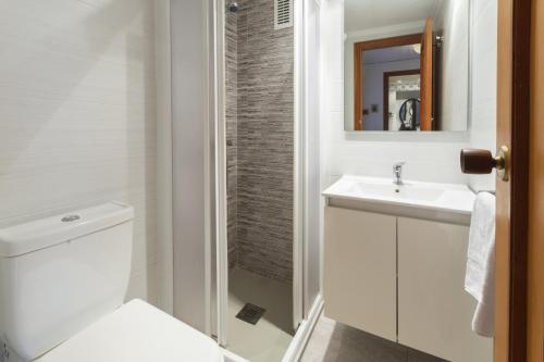 a bathroom with a toilet and a sink and a mirror at Bahamas in Caserío La Estación