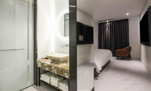 a hotel room with a bathroom with a sink at Incheon Guwol Hotel Bay 204 in Incheon