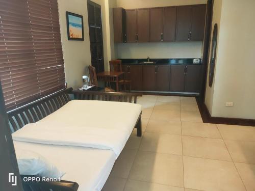 a room with a bed and a kitchen at The Asri Dive and Leisure Resort in Batangas City