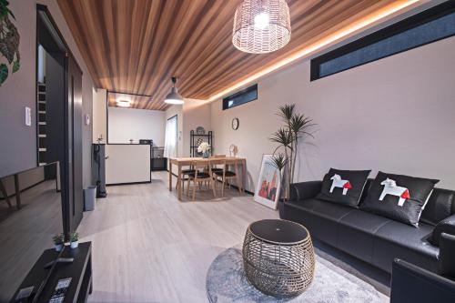 a living room with a couch and a table at -旅タイム 玉出東- 岸里玉出駅 in Osaka