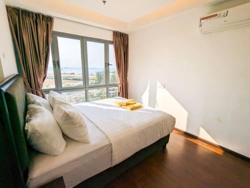a bedroom with a bed with a large window at Lovina 9-17 at Harbour Bay Residence(Near Ferry) in Batu Ampar