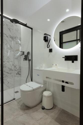 a bathroom with a toilet and a sink and a mirror at Hotel La Milagrosa in Alicante