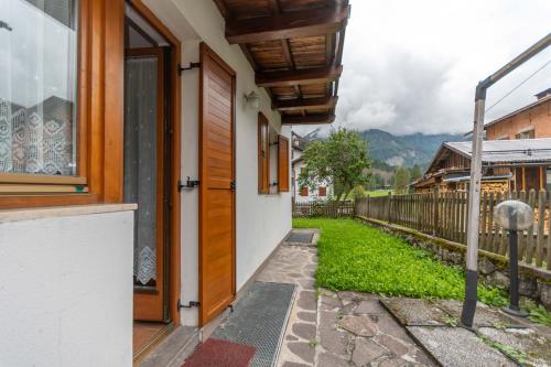 a door to a house with a yard at Casa Alice in Falcade