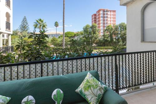 a couch on a balcony with a view of a building at Marina de la Duquesa 805 in Manilva