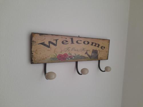 a welcome sign hanging on a wall at Nikola NS2 in Novi Sad