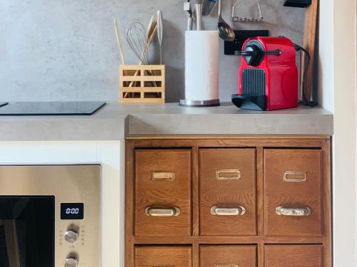 a kitchen counter with a red suitcase on top of it at Zolder appartement Le Grenier in Dilsen-Stokkem