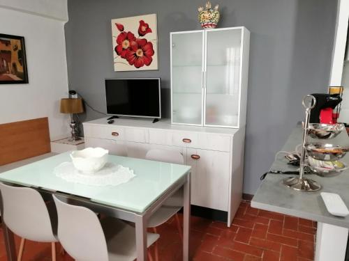 a dining room with a table and a tv at Casa Cartujet in Calaceite