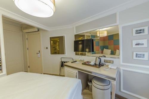 Ένα ή περισσότερα κρεβάτια σε δωμάτιο στο The Constantine Hotel