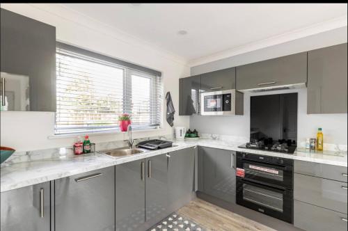 a kitchen with stainless steel appliances and a window at Entire Immaculate 3 Bedrooms House in Blackburn Weekend Away in Blackburn