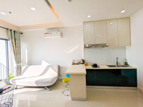 a white kitchen with a sink and a counter at Lovina 21-07 at Harbour Bay Residence(Near Ferry) in Batu Ampar
