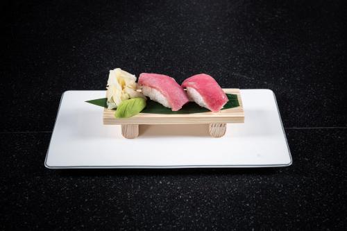 a plate of sushi on top of a table at The St. Regis Astana in Astana