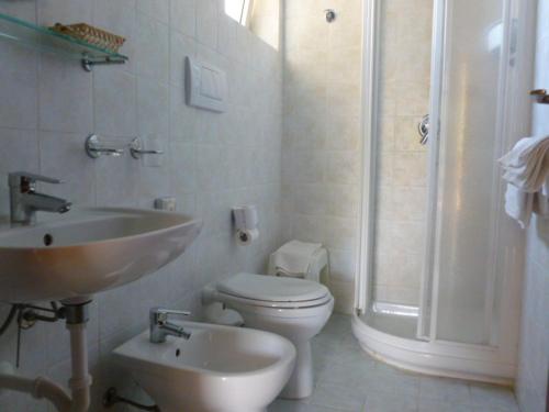 a bathroom with a sink and a toilet and a shower at B & B Summer in Marciana