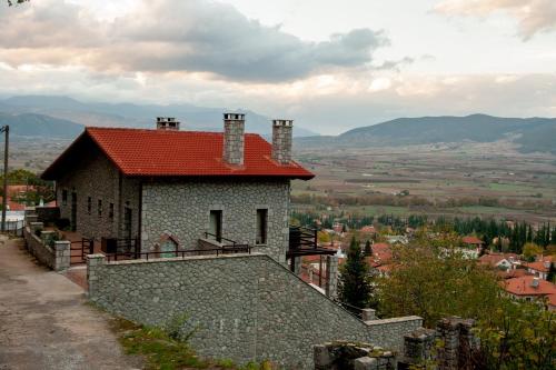 a house with a red roof on top of a hill at PS Apartment Polydrosos - PS Rental in Polydrossos