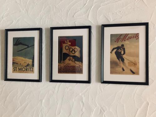 three framed pictures hanging on a wall at Chesa-strimer - Terrassa in La Punt-Chamues-ch