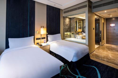 Ένα ή περισσότερα κρεβάτια σε δωμάτιο στο Hilton Xi'an High-tech Zone