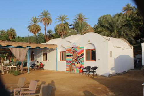 a building with a mural on the side of it at Nile View Guest House in Aswan