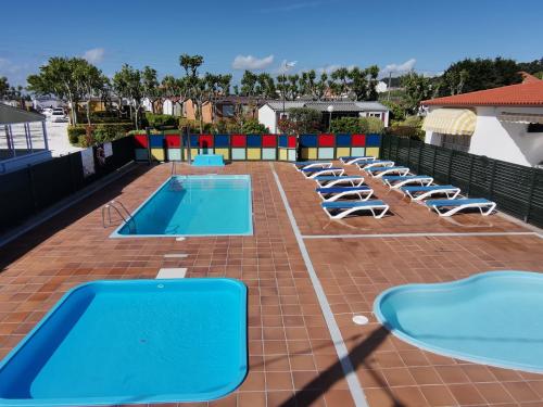 a row of chaise lounges and swimming pools on a roof at Camping Sol y Mar in Pontevedra