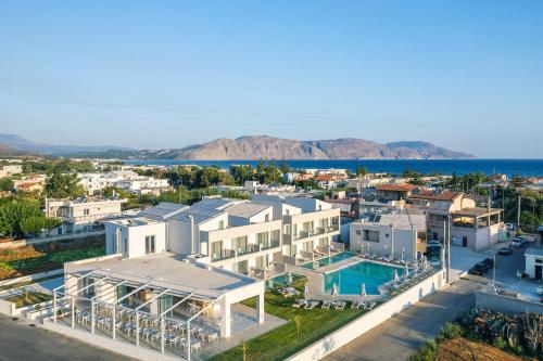an aerial view of a large white house with a pool at Nima Boutique Hotel in Kavros