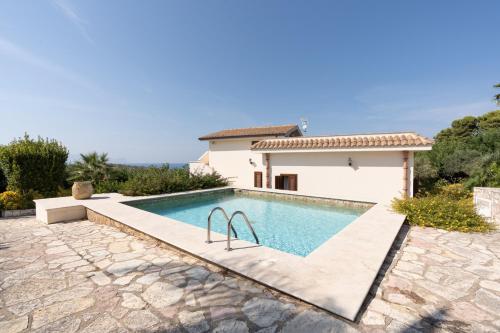 a swimming pool in front of a villa at Villa Zagara in Partinico