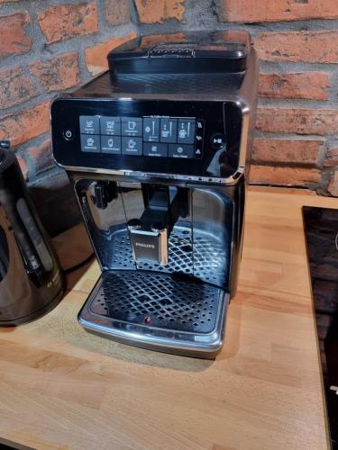 a coffee maker sitting on top of a table at Apartament Wysoka Brama 1/4 in Gryfice