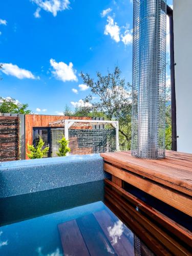 a swimming pool on the deck of a house at Elysian Fields - Tiny House 'Evergreen' in Sadu