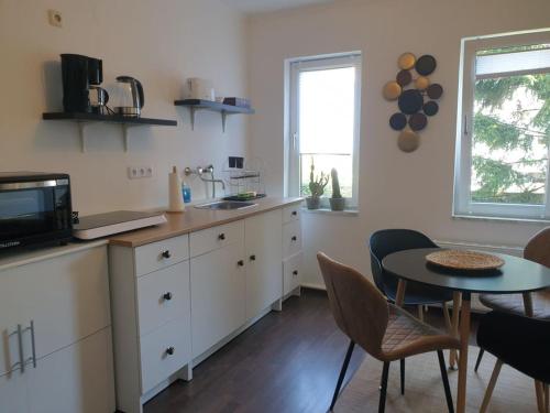 a kitchen with a table and a small table with chairs at Schöne Wohnungen in Essen in Essen