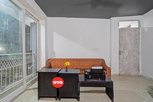 a living room with a couch and a table at OYO Sunrise Villa Near Select Citywalk Mall in New Delhi