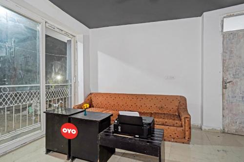 a living room with a couch and a table at OYO Sunrise Villa Near Select Citywalk Mall in New Delhi