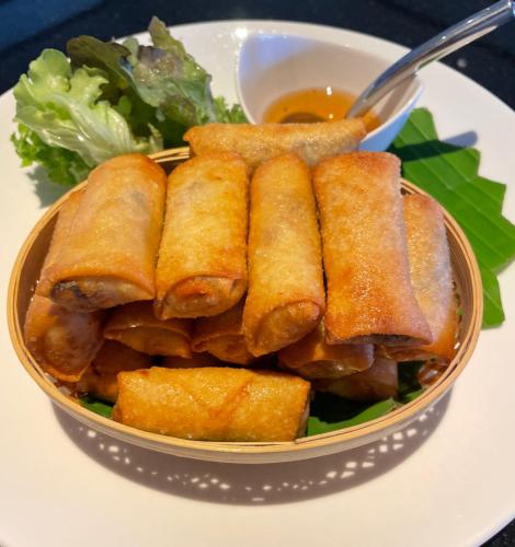 a bowl of food with a bowl of dipping sauce at Villa Nilaya - Beachfront Villa - Hua Hin in Ban Bo Fai