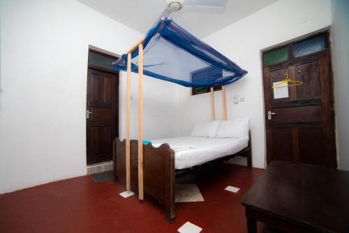 Cama ou camas em um quarto em Flamingo Guest House ZNZ
