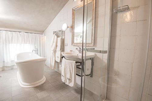a bathroom with a sink and a toilet and a shower at Castello Bonaria Wine & Spa Resort in Campiglia Marittima