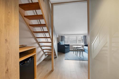 a hallway with a staircase leading to a living room at Clarion Hotel Tyholmen in Arendal