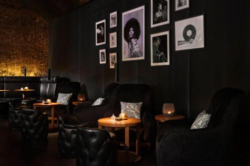 a dark room with chairs and tables and pictures on the wall at The Ritz-Carlton, Vienna in Vienna