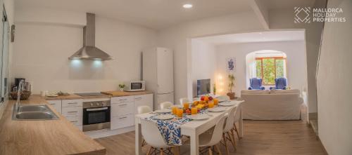 a kitchen with a table with oranges on it at Villa Fonte in Port de Pollensa