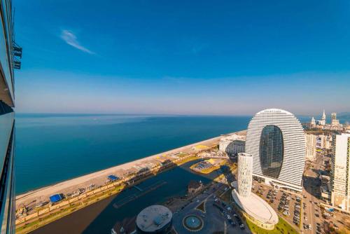 an aerial view of a city and the ocean at Elegance Sea View Aparthotel In Orbi City Batumi in Batumi