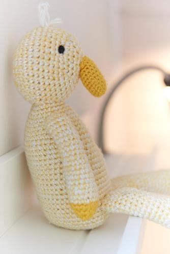a crochet teddy bear is sitting on a table at Ferienwohnung Ankerplatz in Bünsdorf