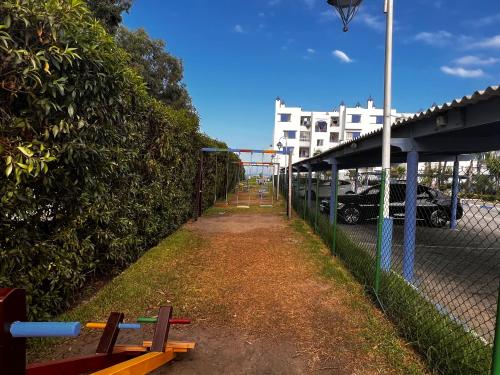 a fence with a bench next to a parking lot at Superbe appart 3pieces a sania plage MARINA SMIR in M'diq